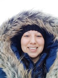 Portrait of smiling young woman in snow