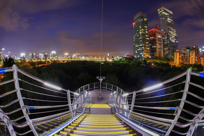 High angle view of illuminated buildings against sky at night