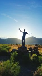 Full length of man standing on field against sky
