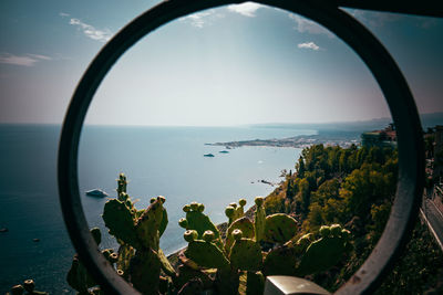 Scenic view of sea against sky seen through glass