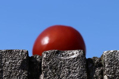 Close-up of rocks against blue sky