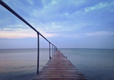 Pier over sea against sky