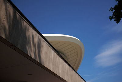 Low angle view of building haus der kulturen der welt against blue sky