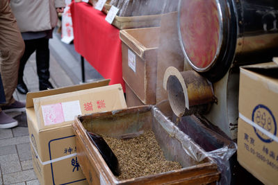 High angle view of dry tea leaves in container at street market