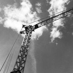 Low angle view of crane against sky