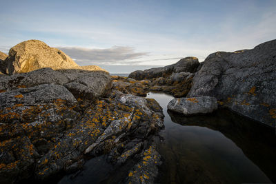 Scenic view of rock formation against sky during sunset