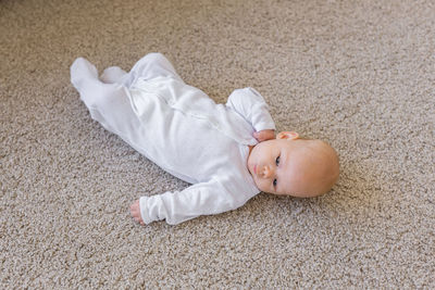 High angle view of baby sleeping on floor