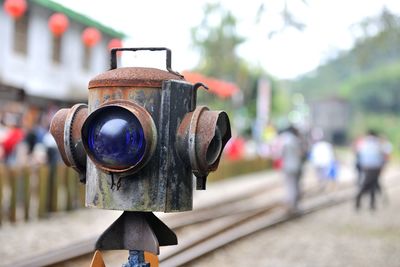 Close-up of weathered railway signal by railroad track