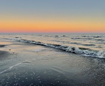 Scenic view of sea against clear sky during sunset