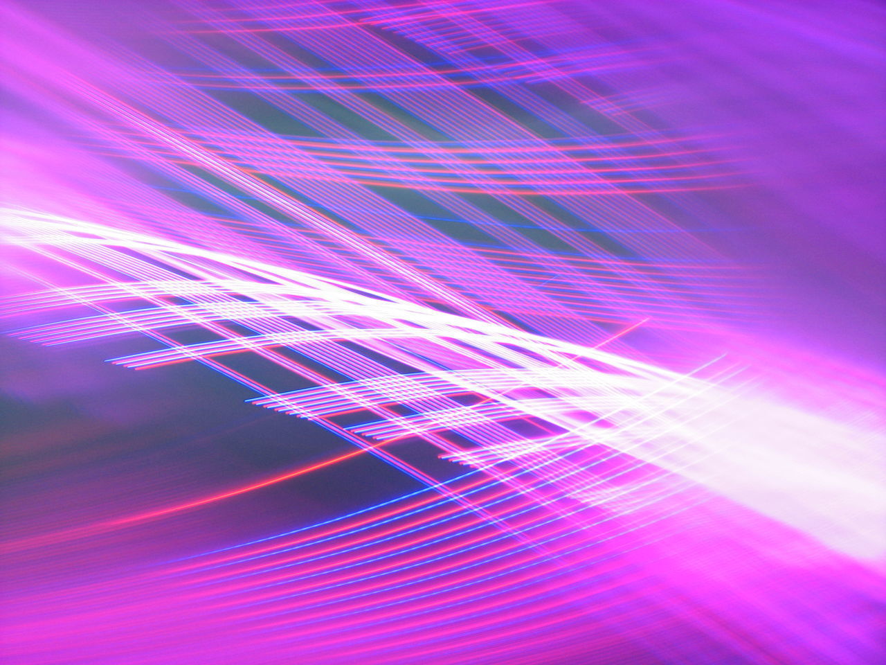 DIGITAL COMPOSITE IMAGE OF LIGHT TRAILS OVER PURPLE BACKGROUND