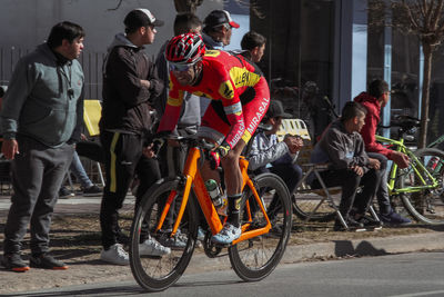 People with bicycle on road in city