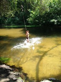 Full length of person on swing in water