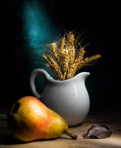 Close-up of apple on table against black background