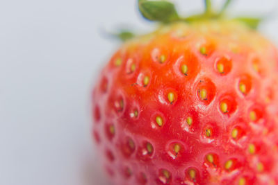 Close-up of strawberry over white background