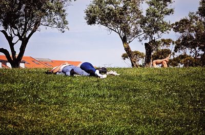 People standing on grassy field