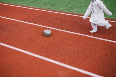 Low section of boy running on sports track