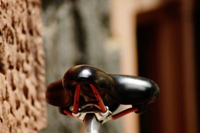 Close-up of bicycle against wall