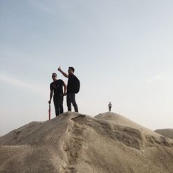 People on desert against sky