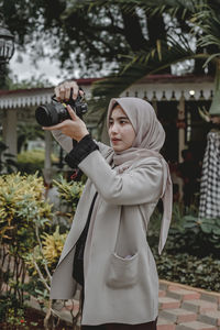 Full length of woman photographing