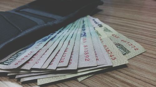 Close-up of paper currencies on table