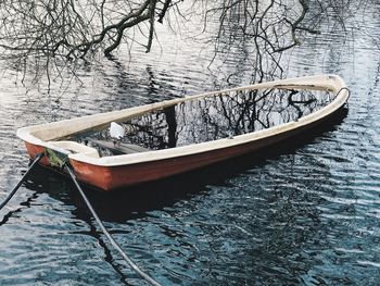 Boat moored in lake during winter