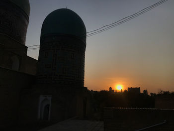 Low angle view of silhouette buildings against sky during sunset