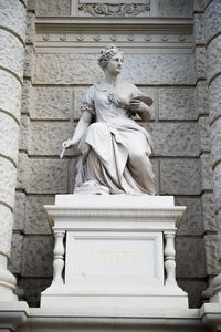 Low angle view of statue against building