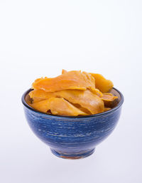 Close-up of bread in bowl against white background