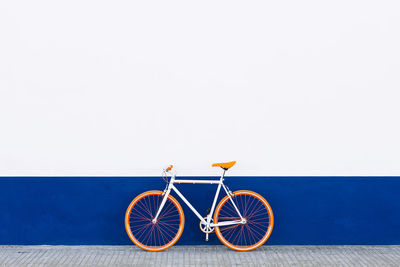 Bicycle against yellow wall