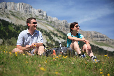 Young man smiling while sitting on land