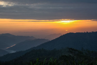 Scenic view of mountains against sky at sunset