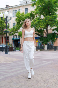 Happy young beautiful woman walking down street. portrait cheerful university