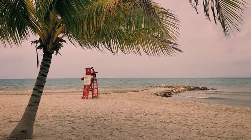 Lifeguard hut on beach against sky
