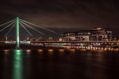 River with illuminated buildings in distance