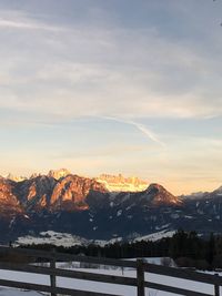 Scenic view of snowcapped mountains against sky during sunset