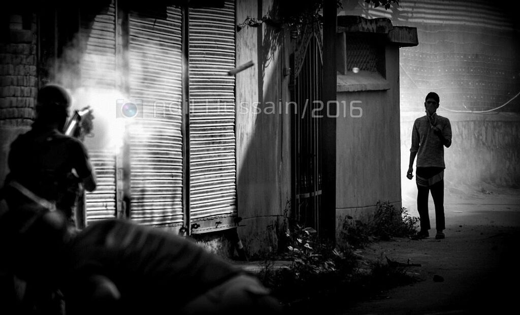 YOUNG MAN STANDING IN THE DARK