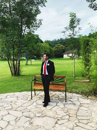 Full length of man wearing suit standing in park