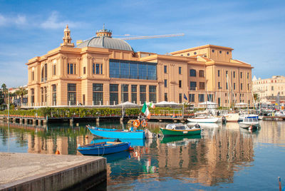 Little harbor with wooden boats and theater in the background, bari, puglia, italy