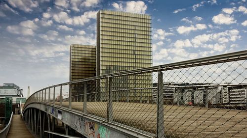 Bridge in city against sky