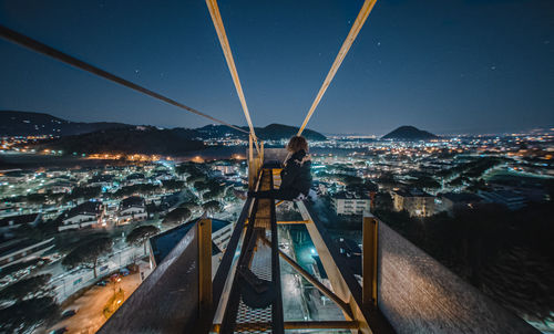 High angle view of illuminated buildings against sky at night