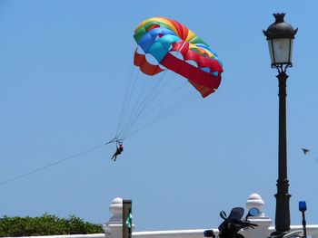 Low angle view of kite against clear blue sky