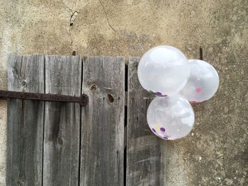 Balloons hanging on concrete wall