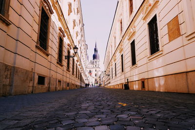 Surface level of alley amidst buildings in city