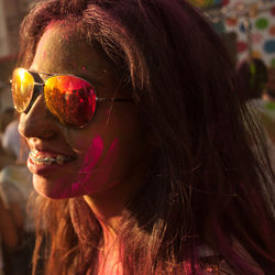 Close-up of messy woman with powder paint during holi