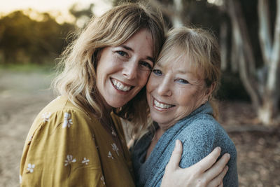 Close up portrait of adult mother and senior mother smiling outside