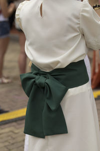 Rear view of woman standing on footpath