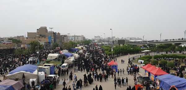 High angle view of people in city against sky