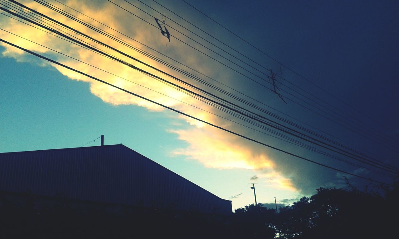 power line, electricity pylon, sunset, silhouette, cable, electricity, power supply, building exterior, low angle view, built structure, architecture, sky, connection, power cable, fuel and power generation, dusk, technology, cloud - sky, city, cloud