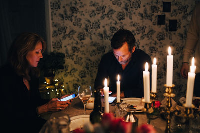 Man and woman sitting on table