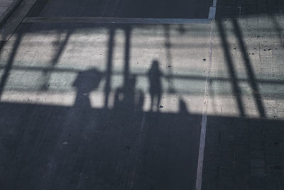 Shadow of people on street in city